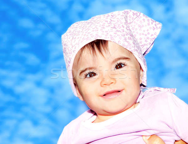 Stock photo: Little girl closeup portrait over sky