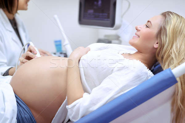 Cheerful pregnant woman on ultrasound Stock photo © Anna_Om