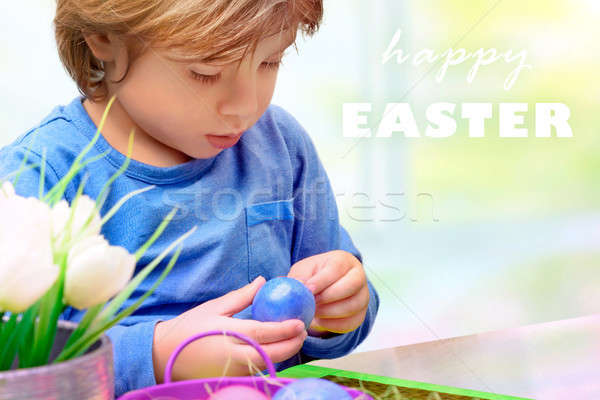 Stock photo: Little boy decorating Easter eggs