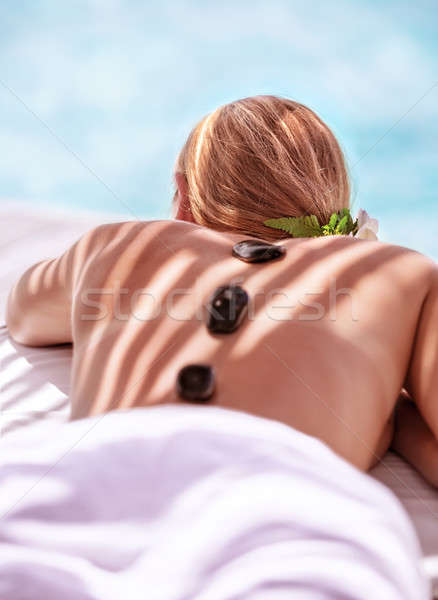 [[stock_photo]]: Chaud · pierre · massage · jolie · jeune · fille · couché · table