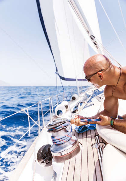 Stock photo: Handsome man on sailboat