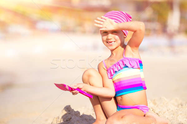Stock photo: Happy little girl playing on the beach