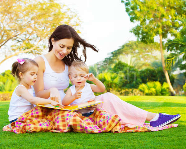 Woman with daughter and son read fairytale Stock photo © Anna_Om