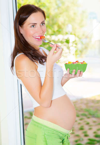 Stock photo: Pregnant girl eating salad