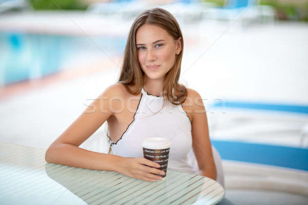 Stock photo: Cute girl having coffee in outdoors cafe