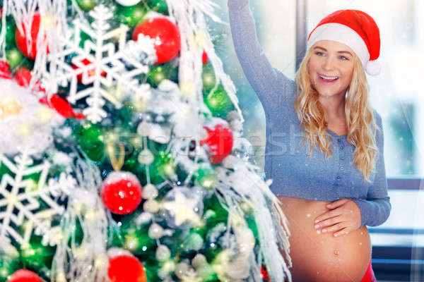 Pregnant woman decorating Christmas tree Stock photo © Anna_Om