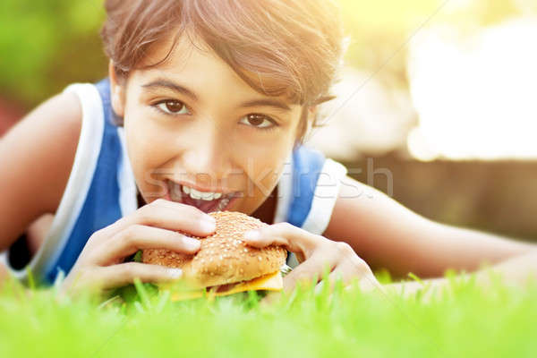Happy boy eating burger Stock photo © Anna_Om