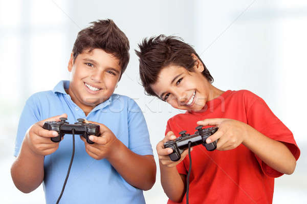 Happy boys playing video games Stock photo © Anna_Om