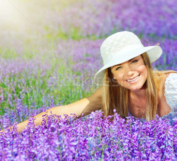 Beautiful happy female lying down on lavender field Stock photo © Anna_Om