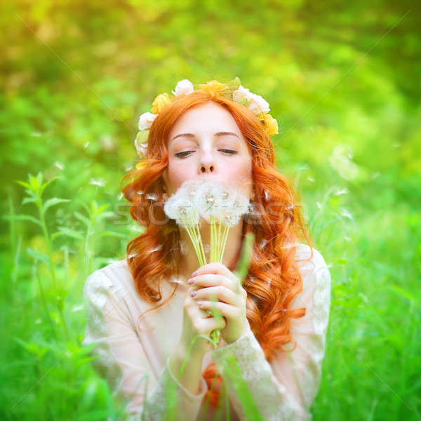 Beautiful female blowing on a dandelion flowers Stock photo © Anna_Om