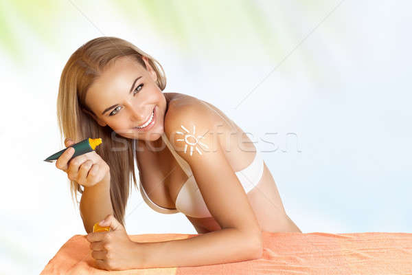 Happy woman applying sunscreen Stock photo © Anna_Om
