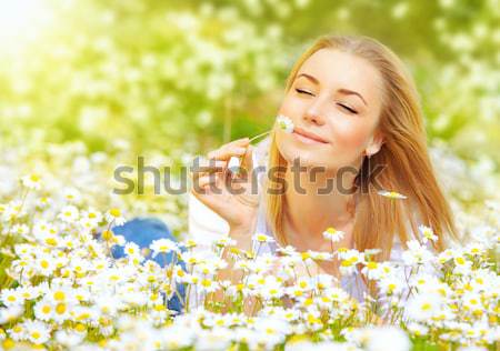 Beautiful female laying on the flower filed Stock photo © Anna_Om