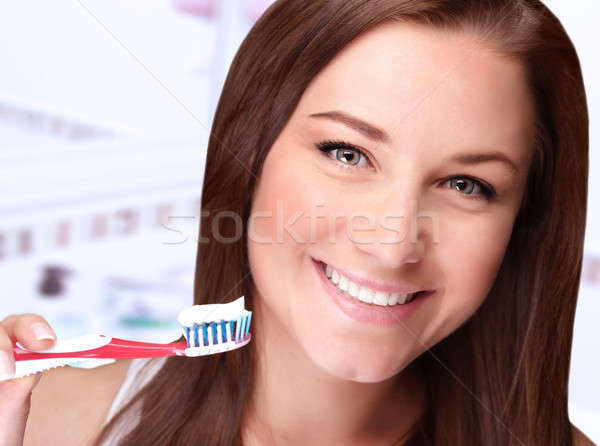 Cute girl cleaning teeth Stock photo © Anna_Om