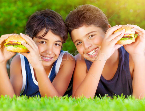 Two boys eating burgers Stock photo © Anna_Om