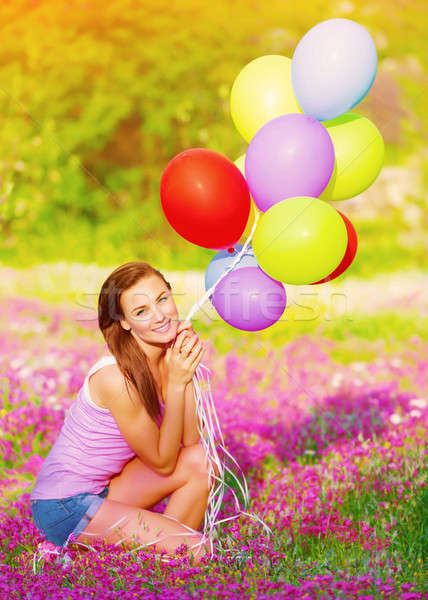 Stock photo: Pretty girl holding colorful balloons