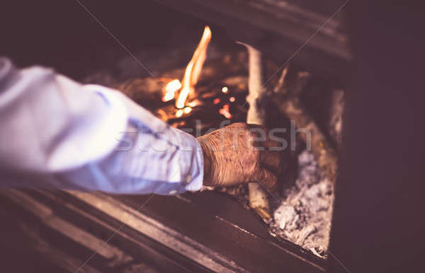 Man kindle a fire in the fireplace Stock photo © Anna_Om