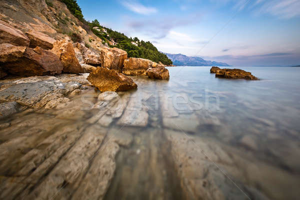 Rocky Beach and Transparent Adriatic Sea near Omis in the Evenin Stock photo © anshar