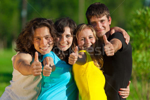 Young group of happy friends showing thumbs up sign Stock photo © Antartis