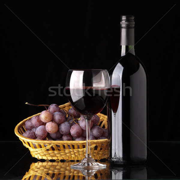 A bottle of red wine, glass and grapes Stock photo © Antartis