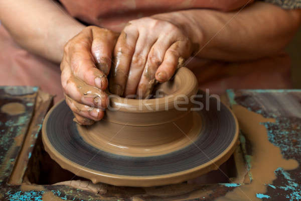 Potter creates a pitcher on a pottery wheel Stock photo © Antartis