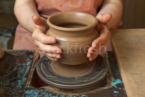 Stock photo: Potter shows just created a pot