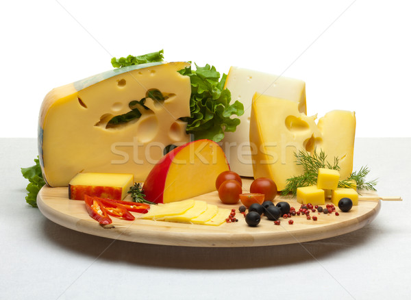 Cheese still life on a wooden round tray Stock photo © Antartis