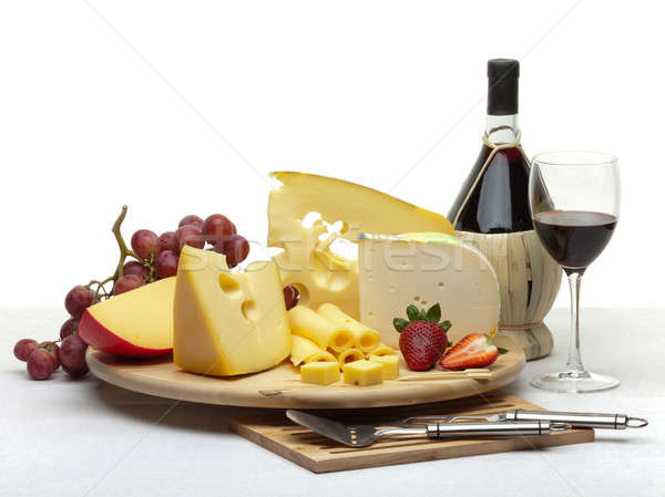 Cheese still life on a wooden round tray Stock photo © Antartis