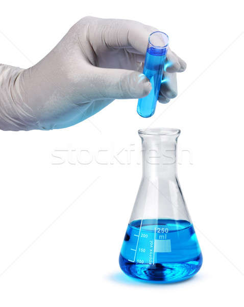 Gloved hand pours blue liquid sample Stock photo © Anterovium