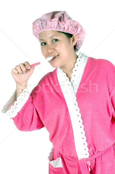 Stock photo: young woman brushing her teeth 
