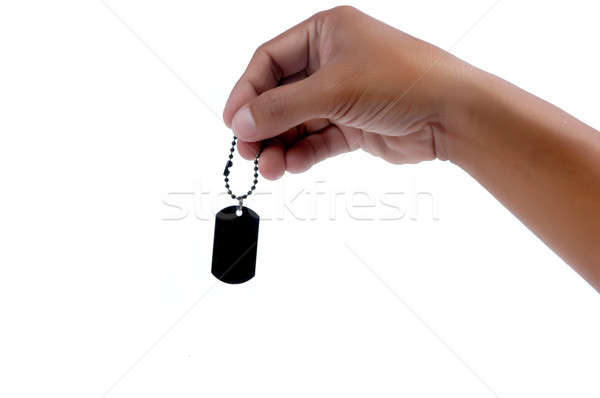 Férfi kéz tart fekete fém címke Stock fotó © antonihalim