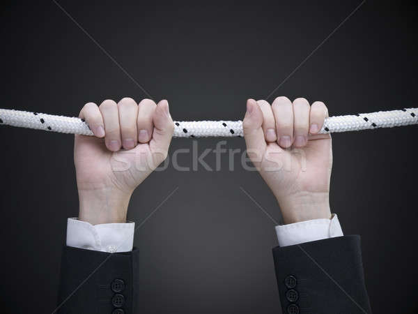 Közelkép kezek akasztás kötél üzlet kéz Stock fotó © antonprado