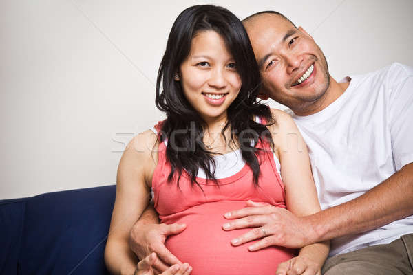 Stock photo: Happy expecting pregnant asian couple