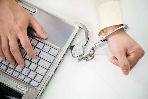  Handcuffed businessman on laptop Stock photo © aremafoto