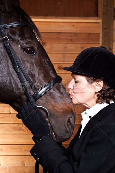 Senior woman kissing her horse Stock photo © aremafoto