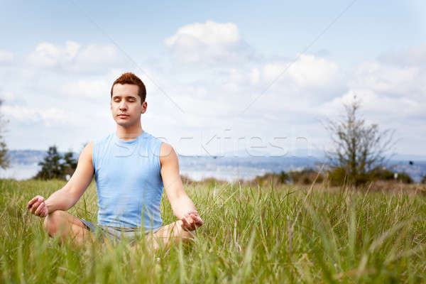 Mixed race man practicing yoga Stock photo © aremafoto