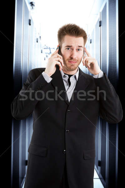 Geschäftsmann sprechen zwei Telefone Stock foto © aremafoto