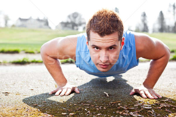 Mixed race man doing push up Stock photo © aremafoto