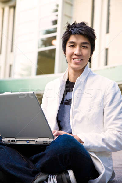 Asian male student and laptop Stock photo © aremafoto