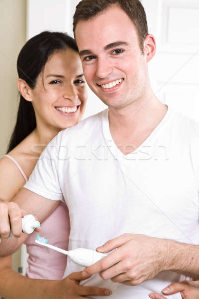 Couple brushing teeth in the bathroom Stock photo © aremafoto