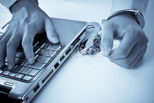  Handcuffed businessman on laptop Stock photo © aremafoto
