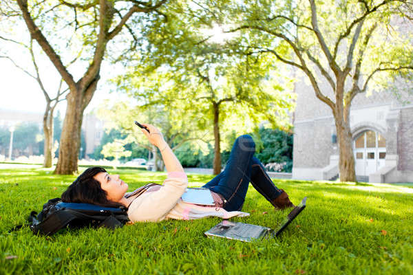 Mixed race student texting Stock photo © aremafoto