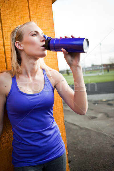 Sporty woman drinking Stock photo © aremafoto