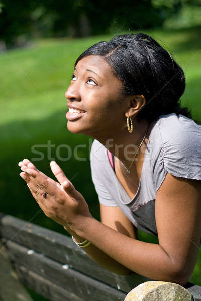 Młoda kobieta modląc na zewnątrz serca patrząc Zdjęcia stock © ArenaCreative