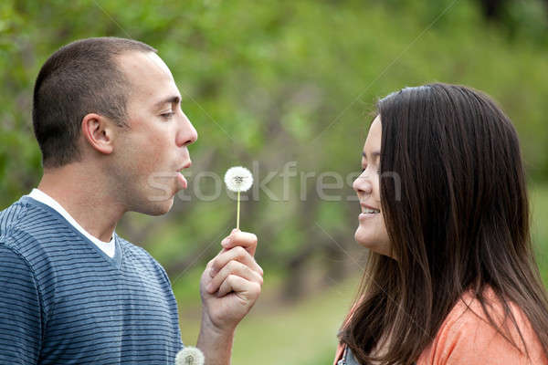 Stock photo: Boyfriend Blows a Dandelion