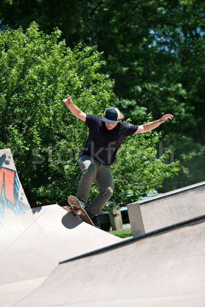 Skateboarder Riding Up a Concrete Skate Ramp Stock photo © ArenaCreative