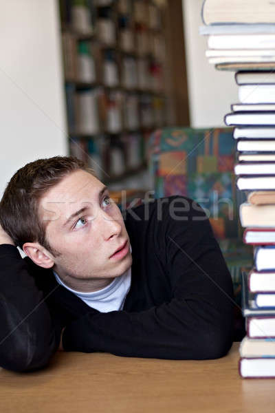 Student Looking Up At Pile of Books Stock photo © ArenaCreative