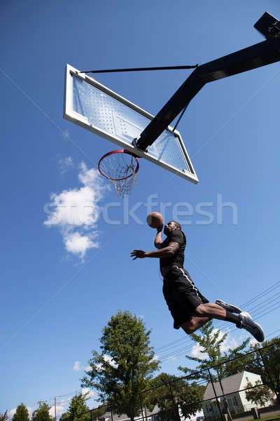 Stock photo: Slam Dunking a Basketball