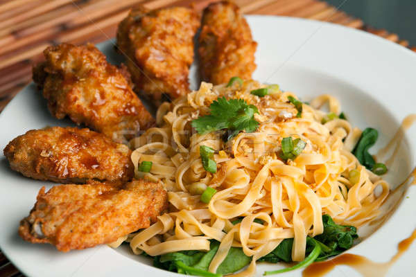 Chicken Wings with Noodles and Spinach Stock photo © arenacreative