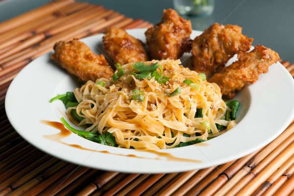 Chicken Wings with Noodles and Spinach Stock photo © arenacreative