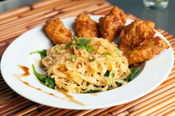 Chicken Wings with Noodles and Spinach Stock photo © arenacreative